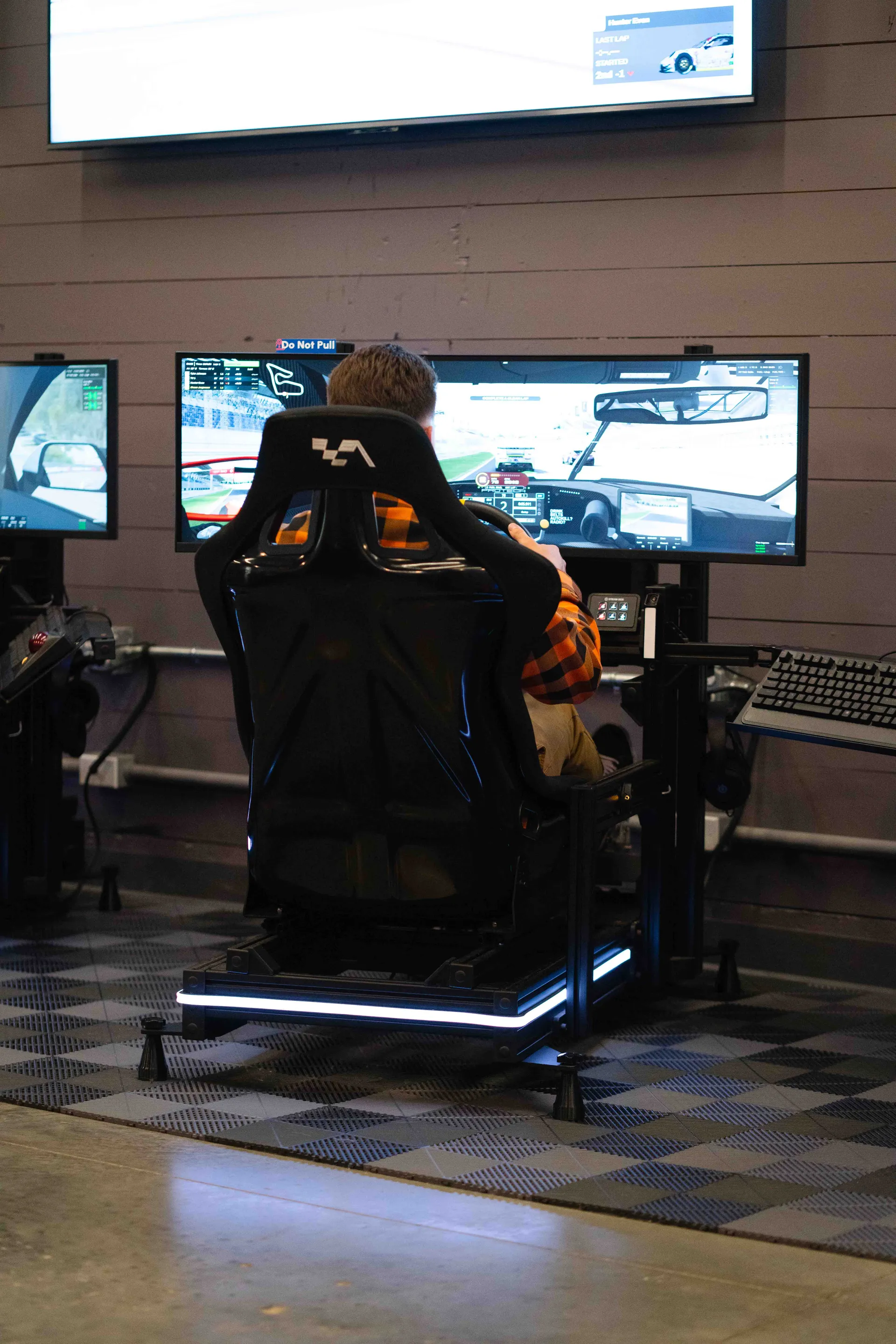 Sim racer locked in at a racing simulator at Grid Lounge Iowa's only sim racing lounge