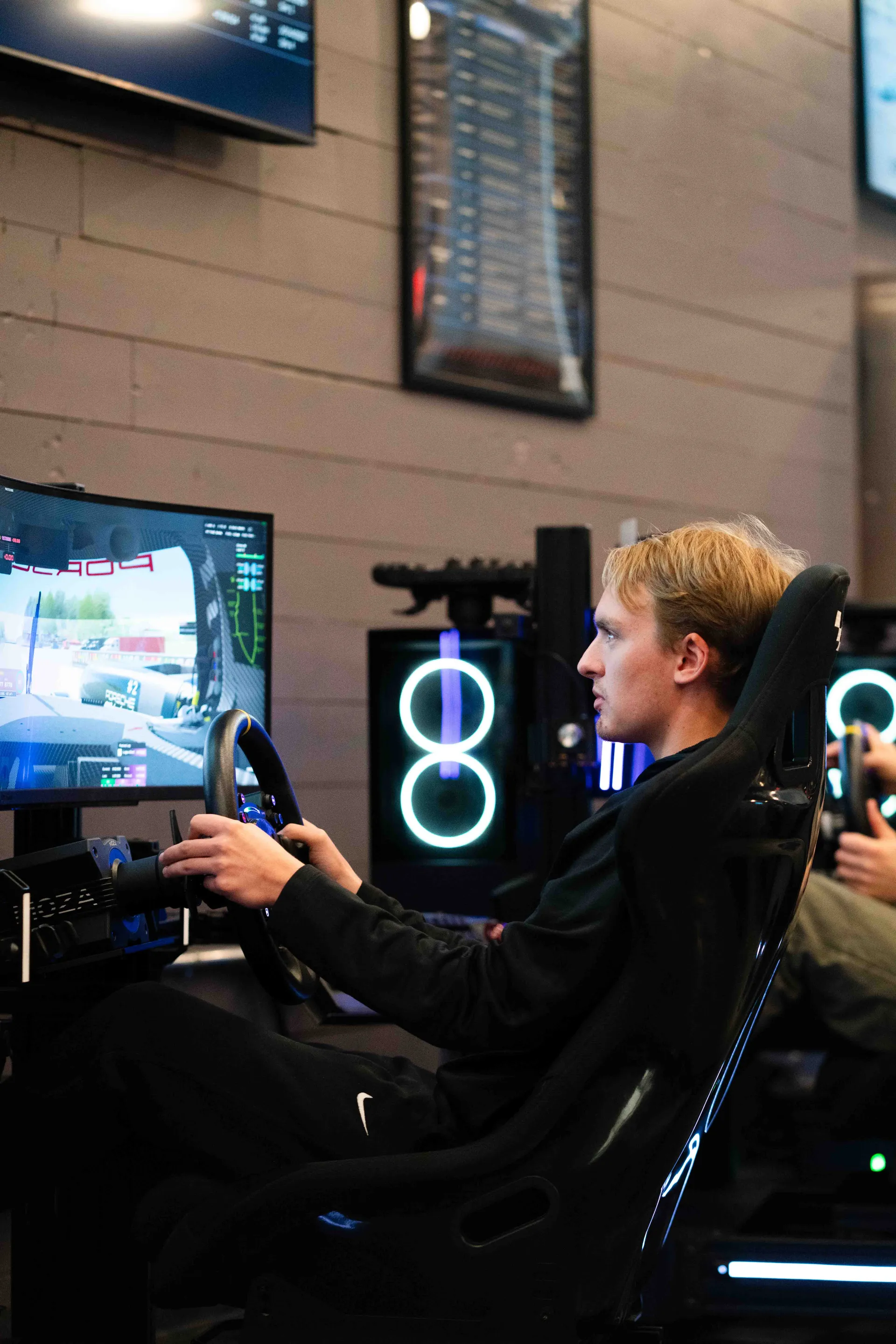 Competitive sim racer focused at a racing simulator rig at Grid Lounge Cedar Falls Iowa