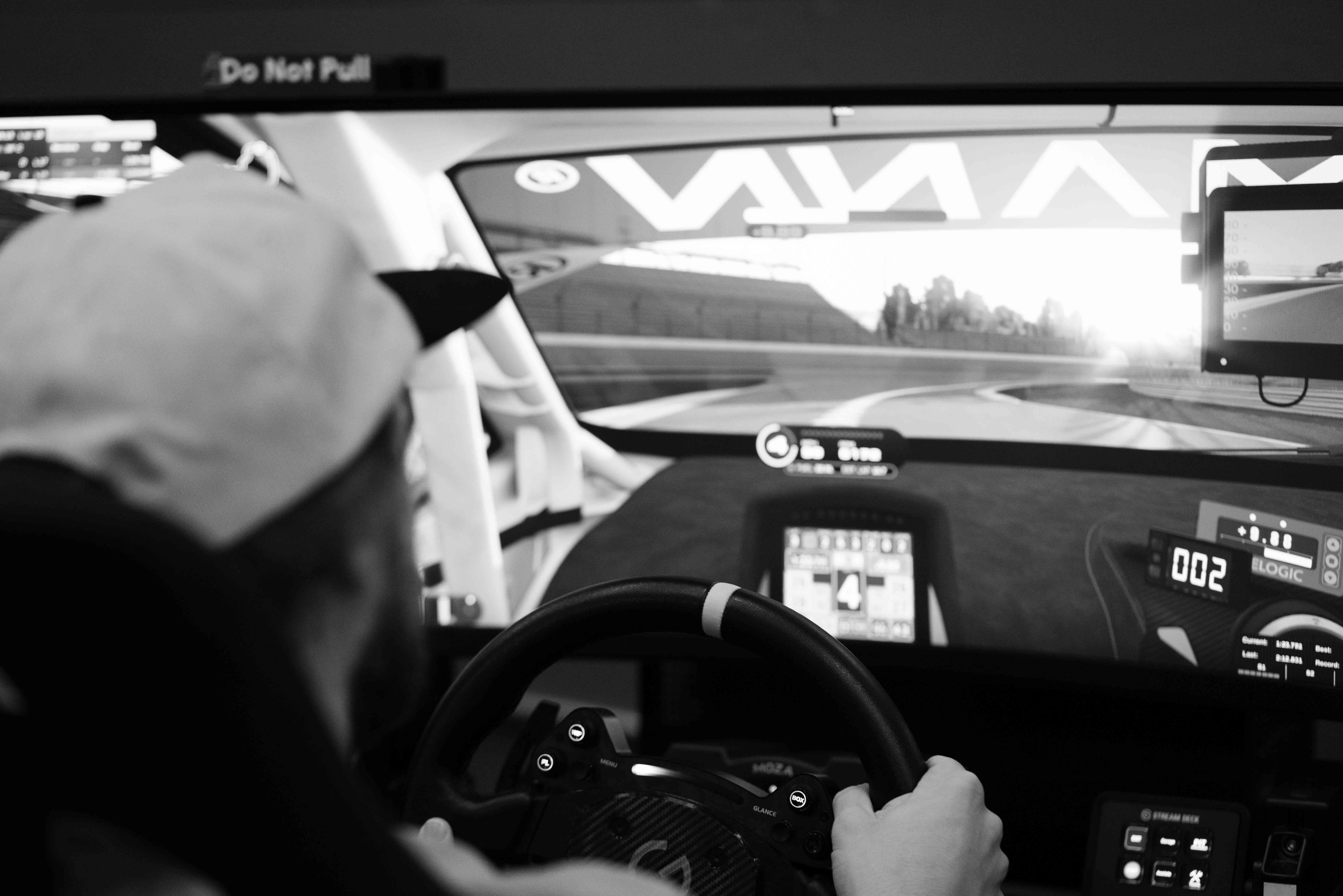 First-time driver getting set up at Grid Lounge sim racing lounge in Cedar Falls Iowa
